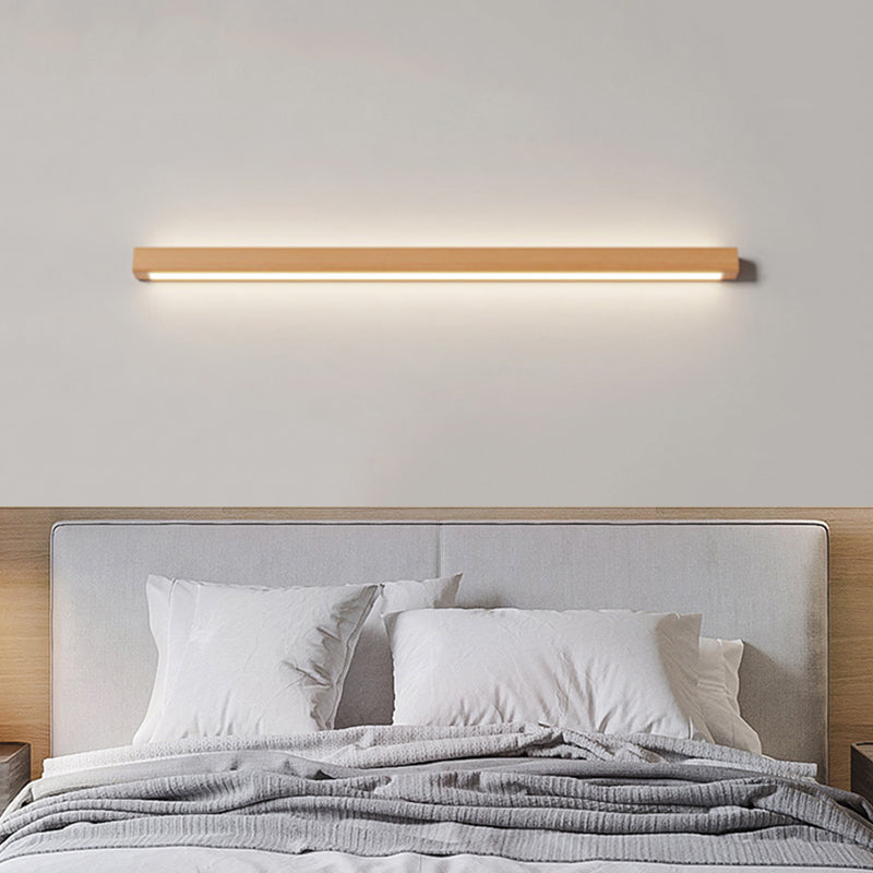 Wood wall light above a bed